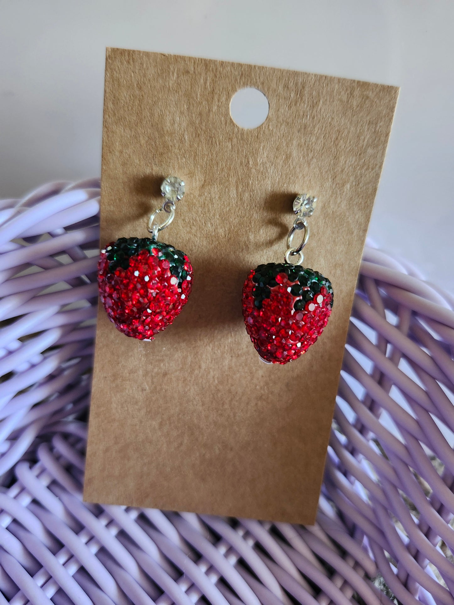 Bedazzled strawberry jewelry earrings with sparkling red glitter and green accents on silver hooks