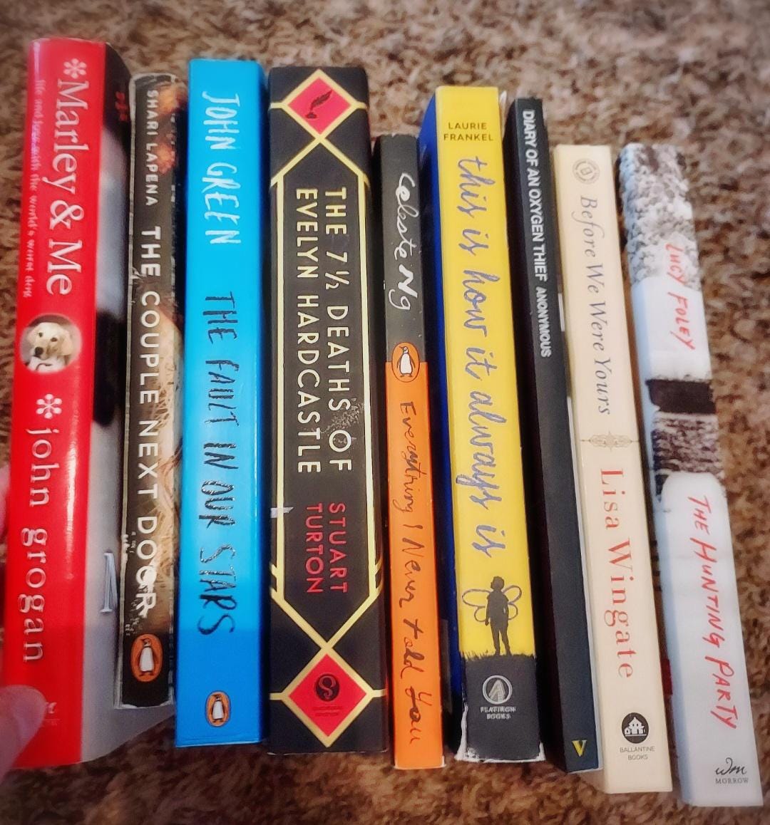 Blind date with a book gift featuring a variety of mystery and romance novels stacked together.