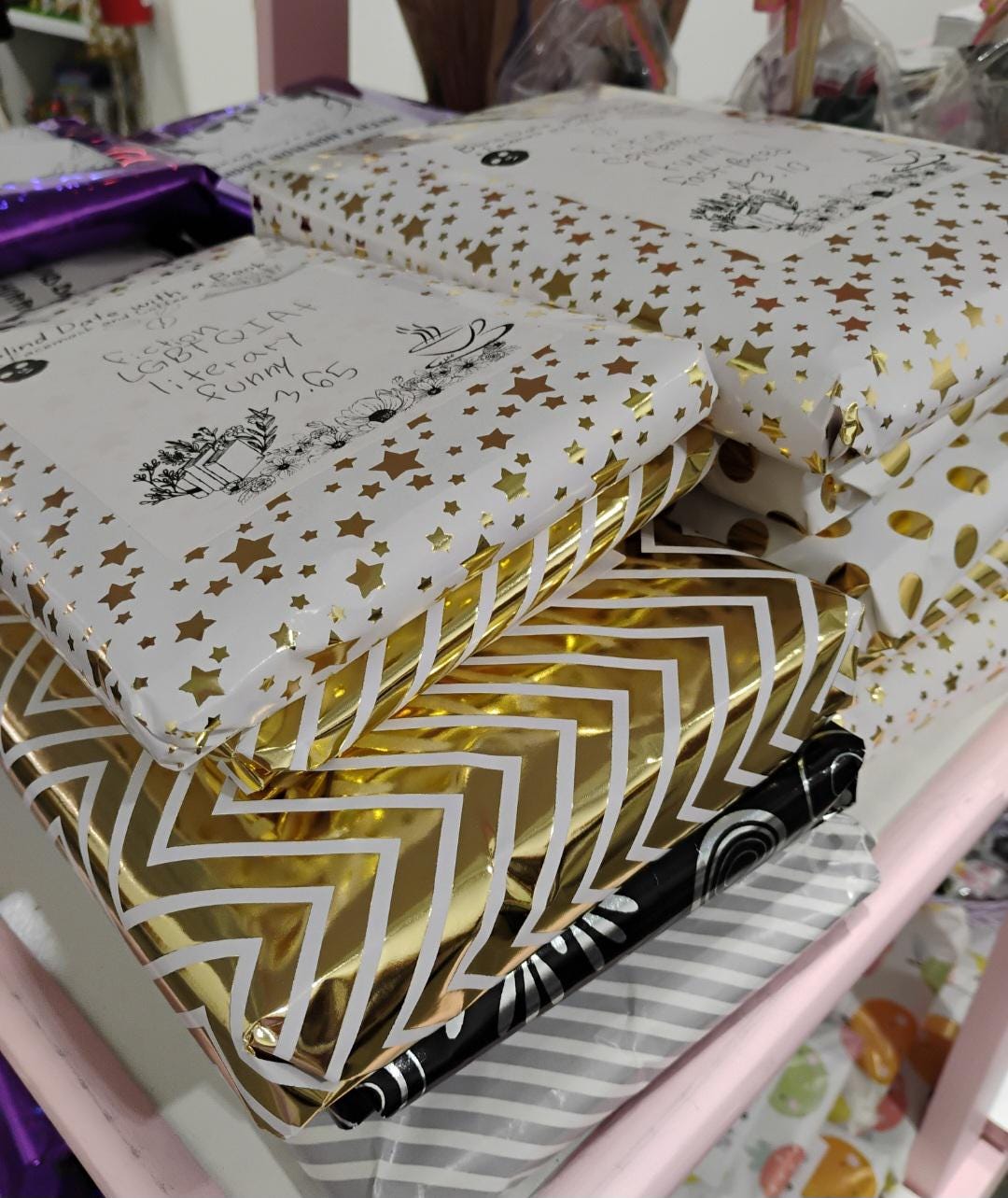 Gift-wrapped blind date with a book gift packages featuring colorful star and chevron designs