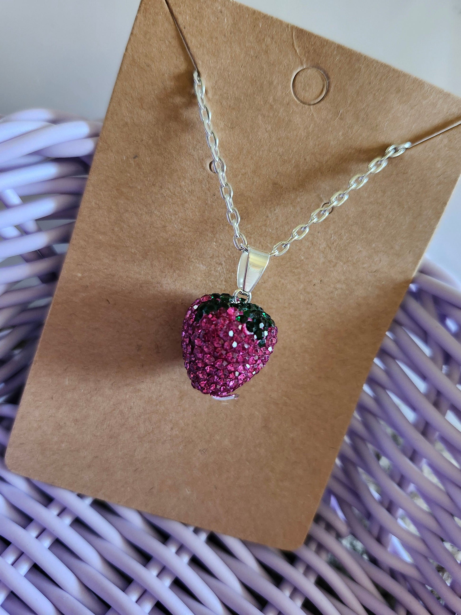 Bling strawberry pendant necklace in pink with black accents on a silver chain