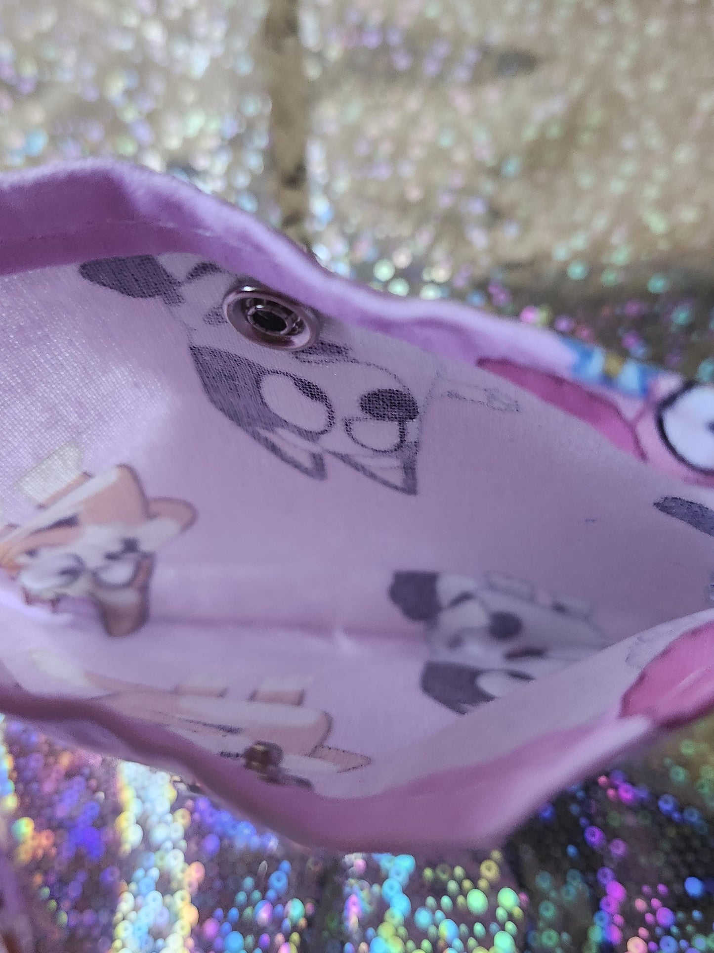Inside view of a Bluey trinket pouch gift featuring colorful character prints on a purple background