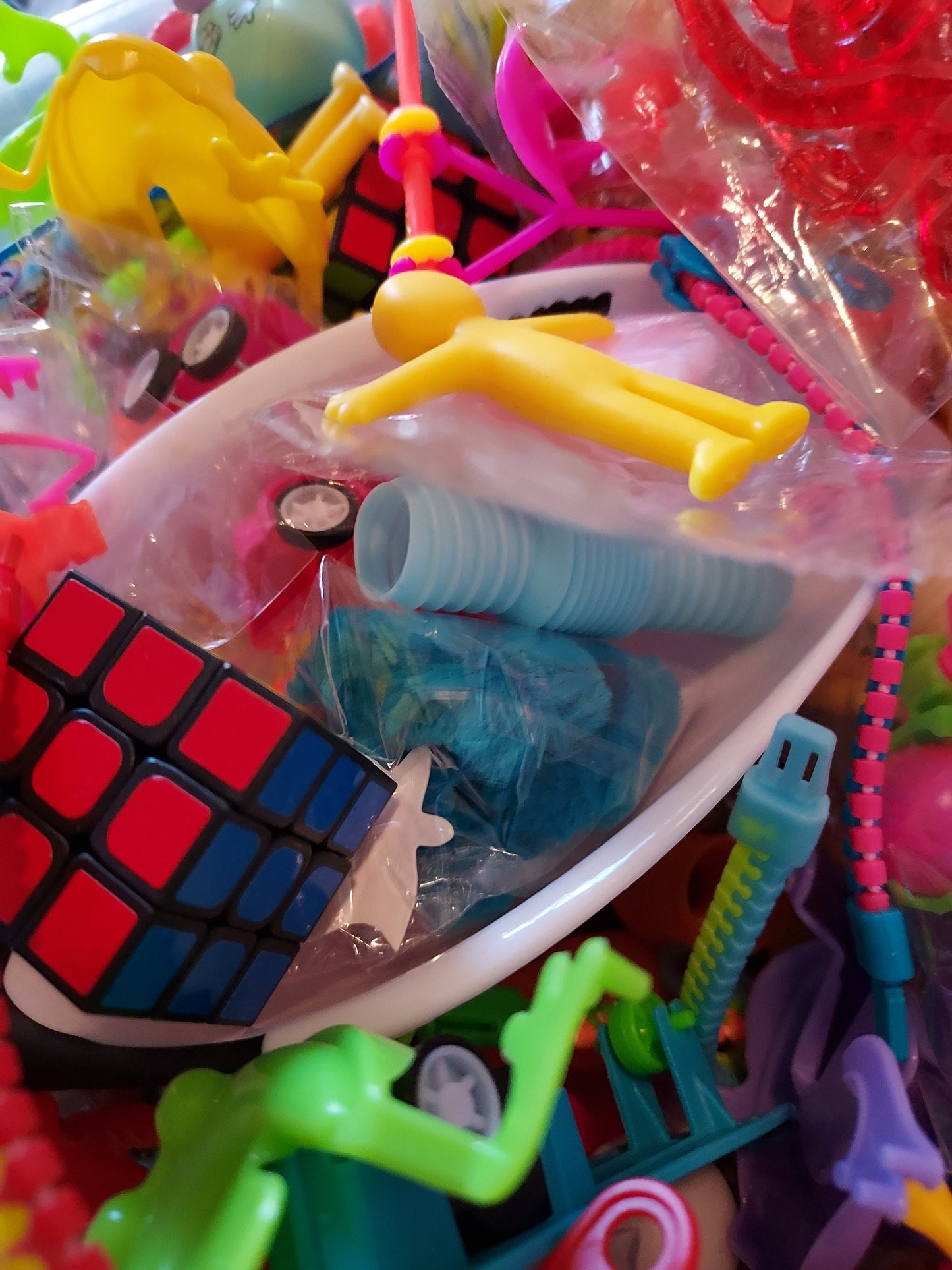Colorful fidget toy mystery grab bag filled with various toys and stress relief items in a bowl