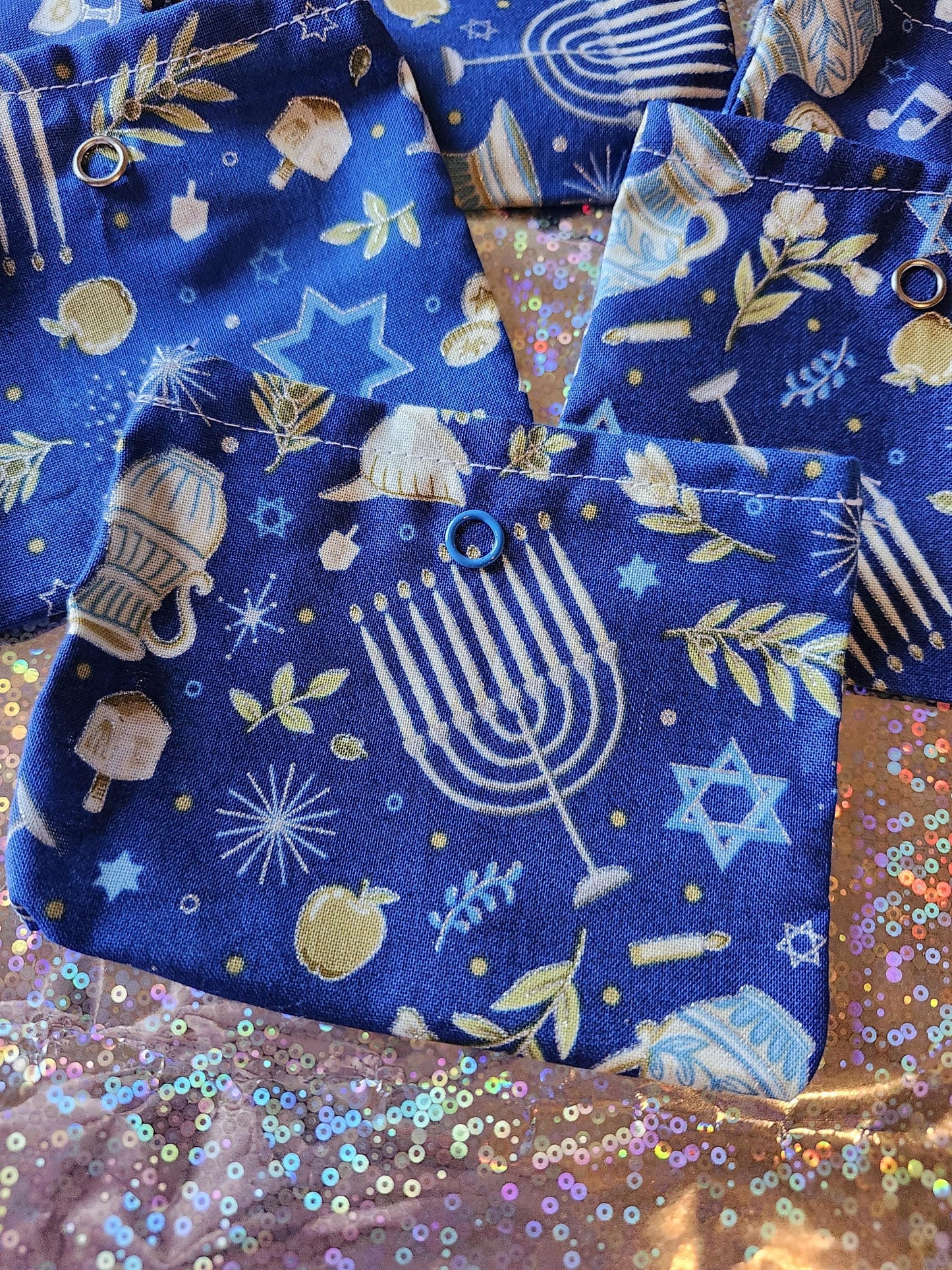 Handmade Hanukkah gift pouch featuring blue fabric with menorah and star designs