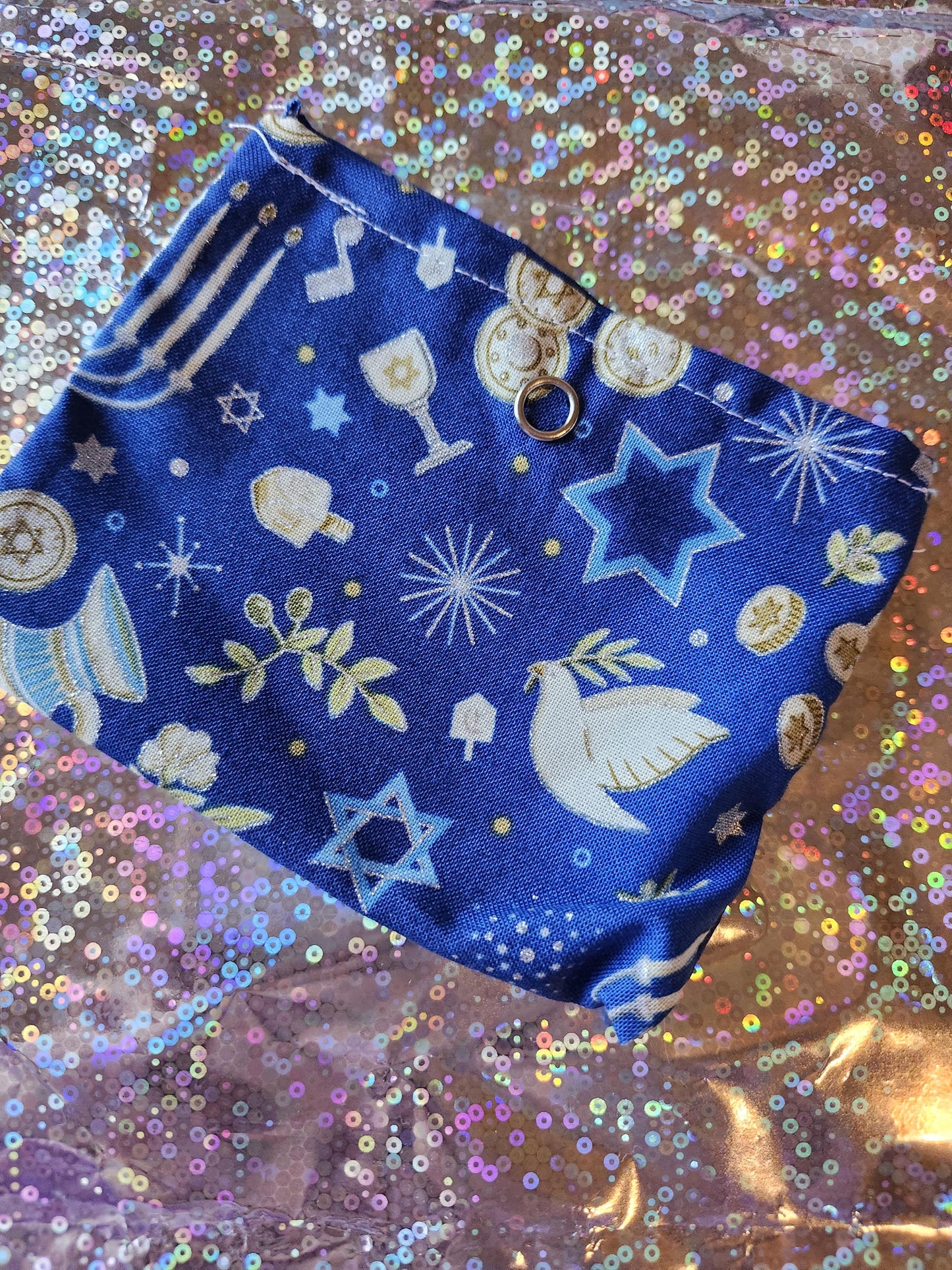 Handmade Hanukkah gift pouch in blue with festive symbols and designs for holiday celebrations