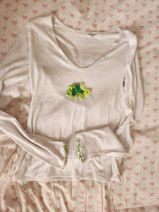 White long-sleeve shirt featuring a handsewn embroidered frog shirt design with colorful beads