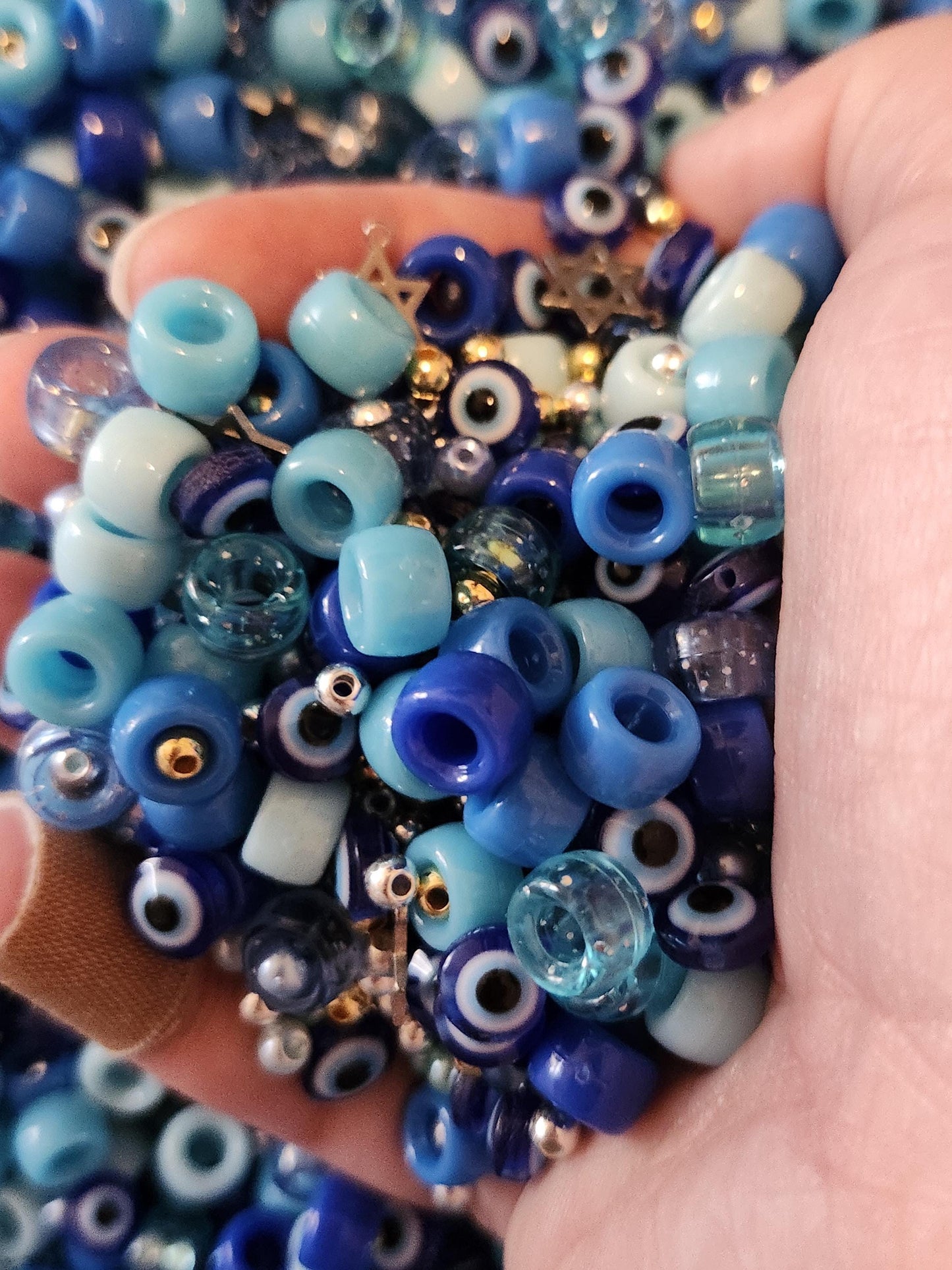 Colorful assortment of beads in blue tones perfect for a Hanukkah jewelry making kit