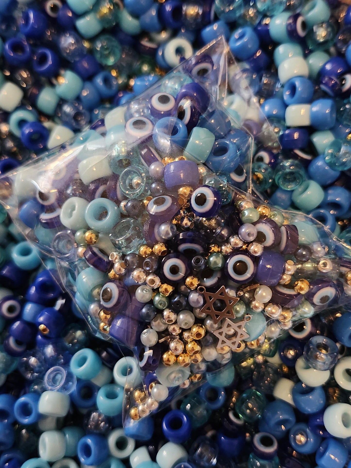Hanukkah jewelry making kit featuring assorted beads in blue and gold hues