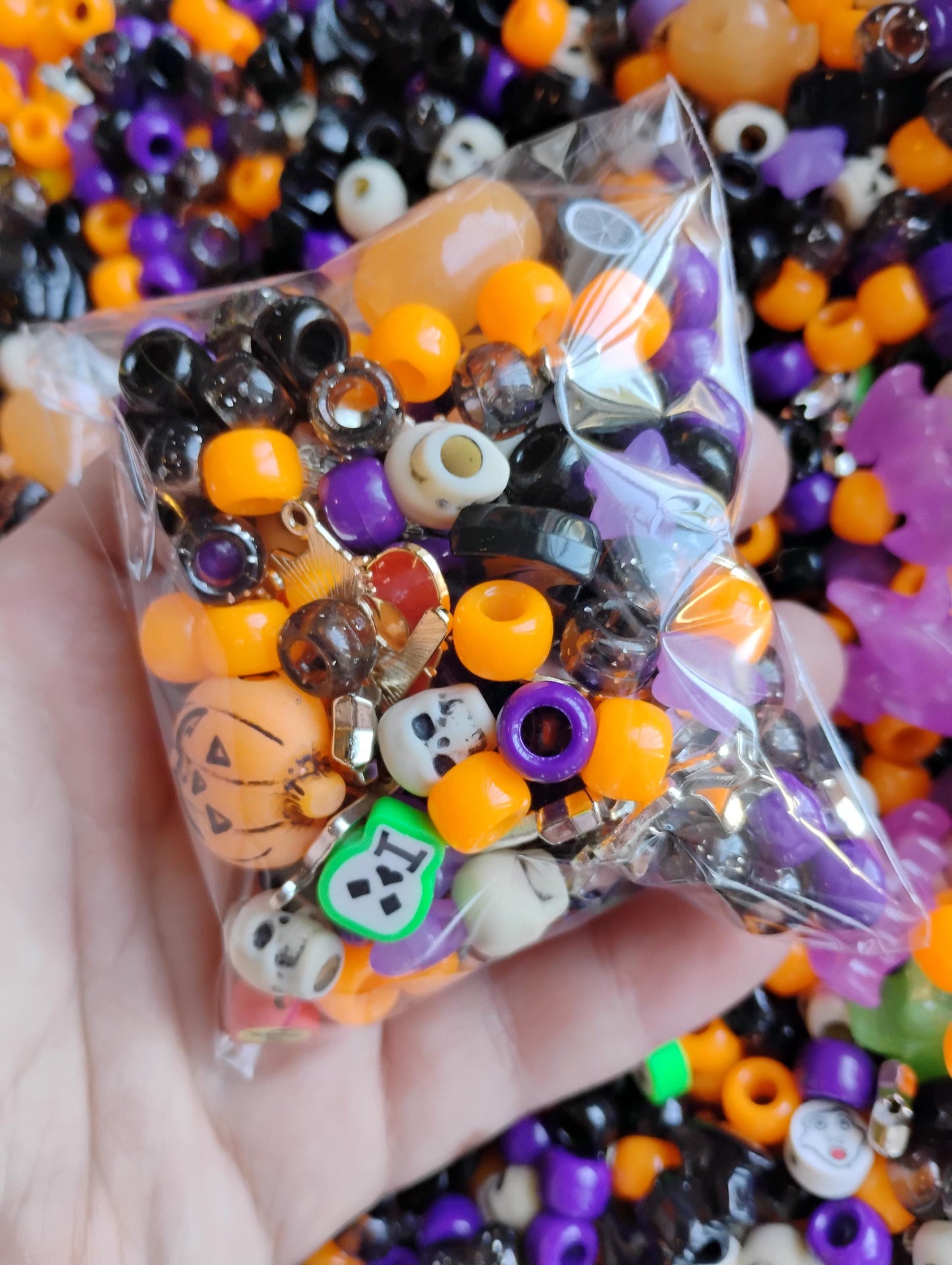 Colorful Kandi beads Halloween mix in a clear bag featuring orange, black, purple, and themed charms