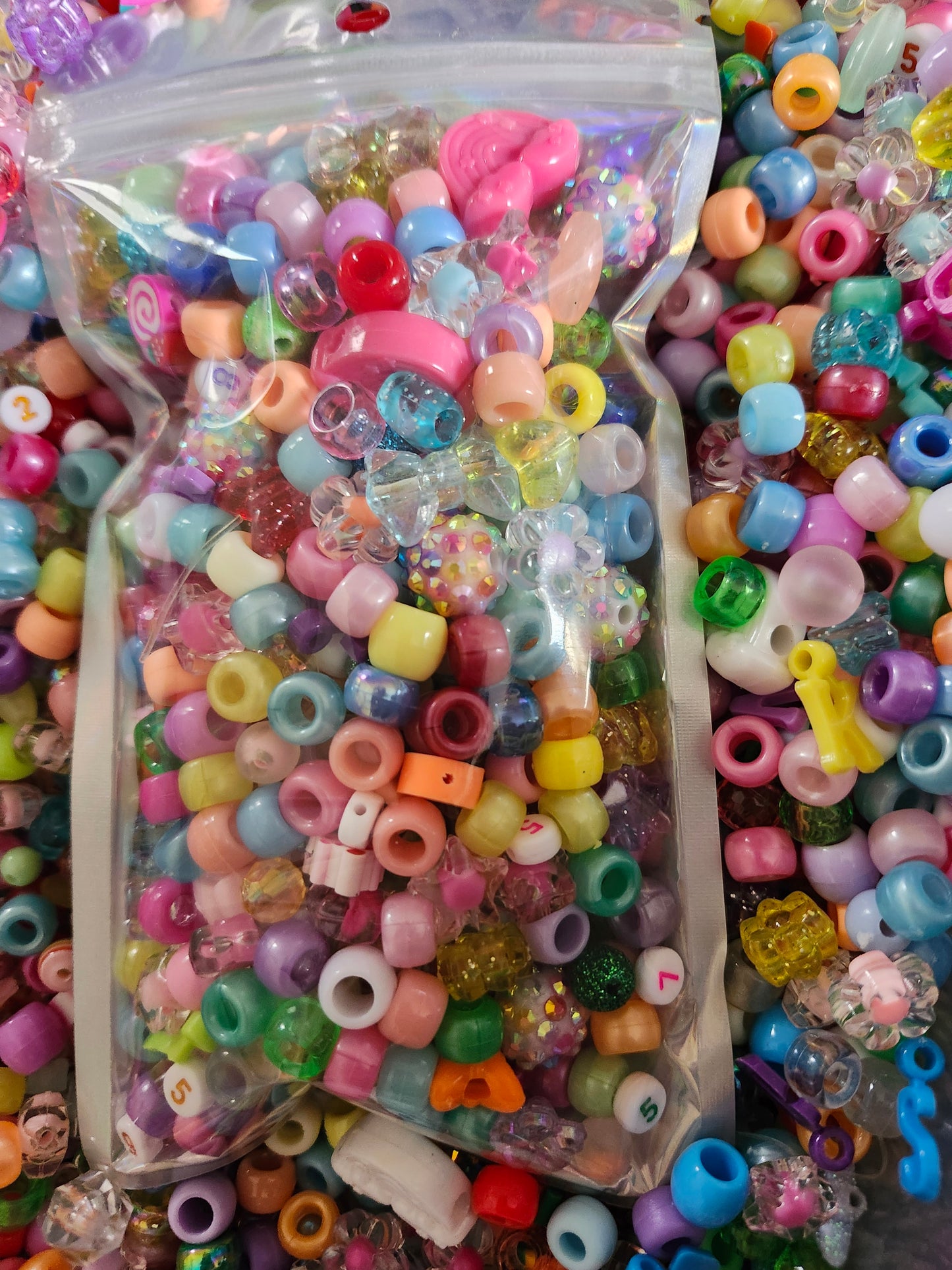 Assorted kawaii bead craft supplies in a clear bag, perfect for DIY jewelry and crafts