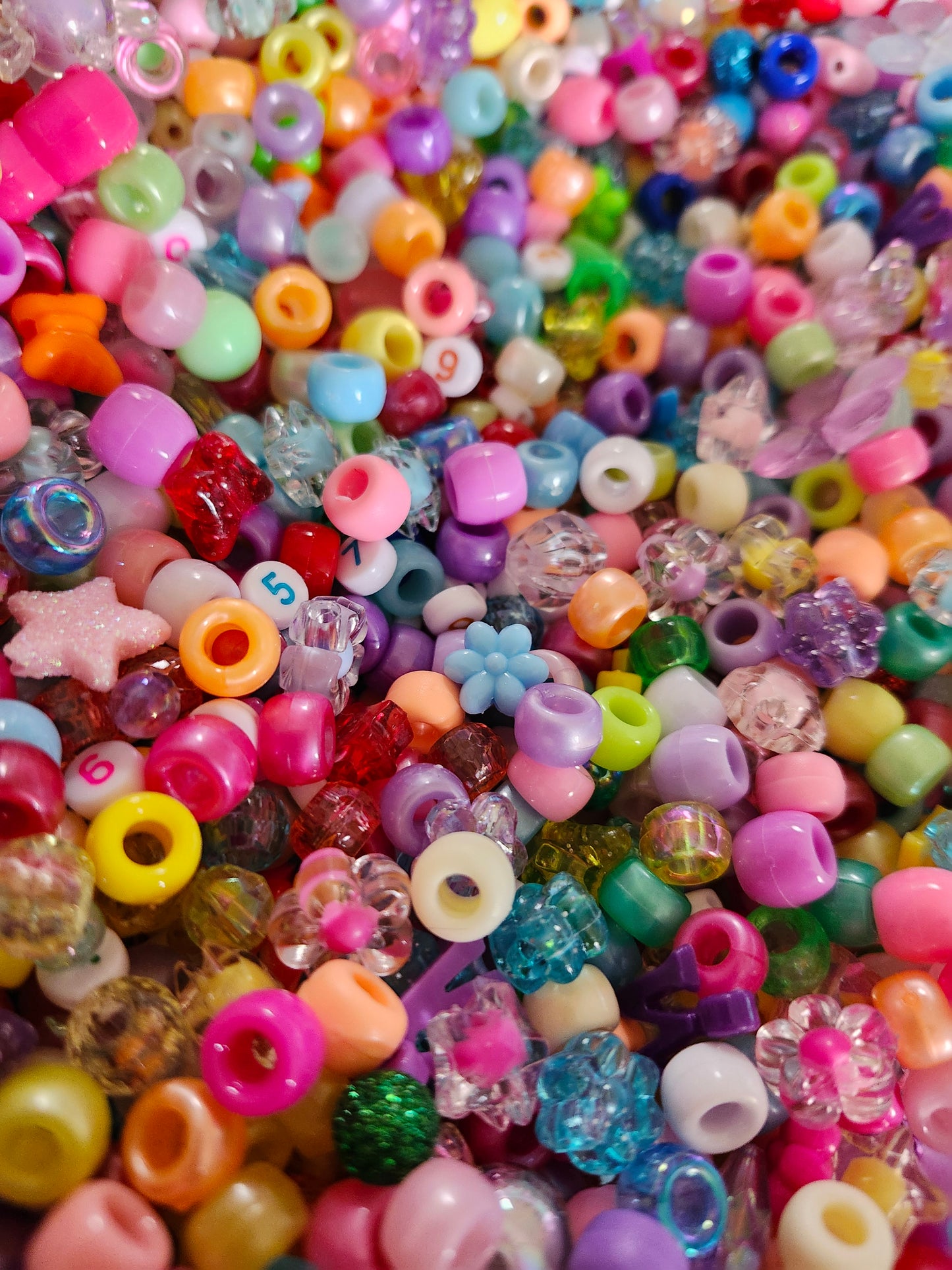 Colorful assortment of kawaii bead craft supplies in various shapes and sizes for creative projects