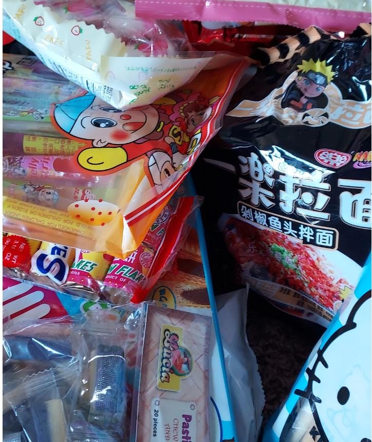 Variety of snacks in an Asian snack box gift featuring colorful packaging and unique treats