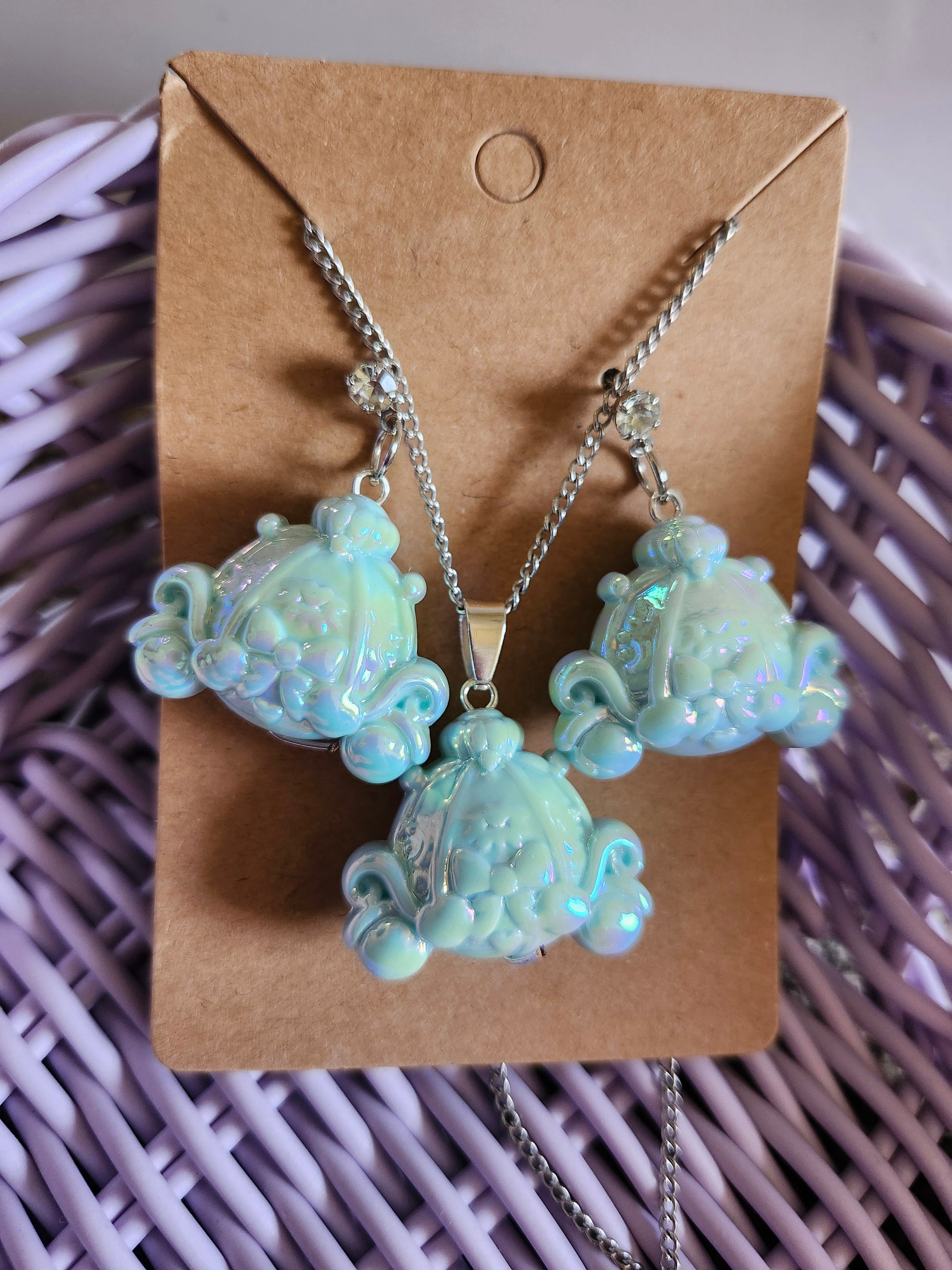 Cinderella themed earrings and necklace set featuring shimmering designs on a display card