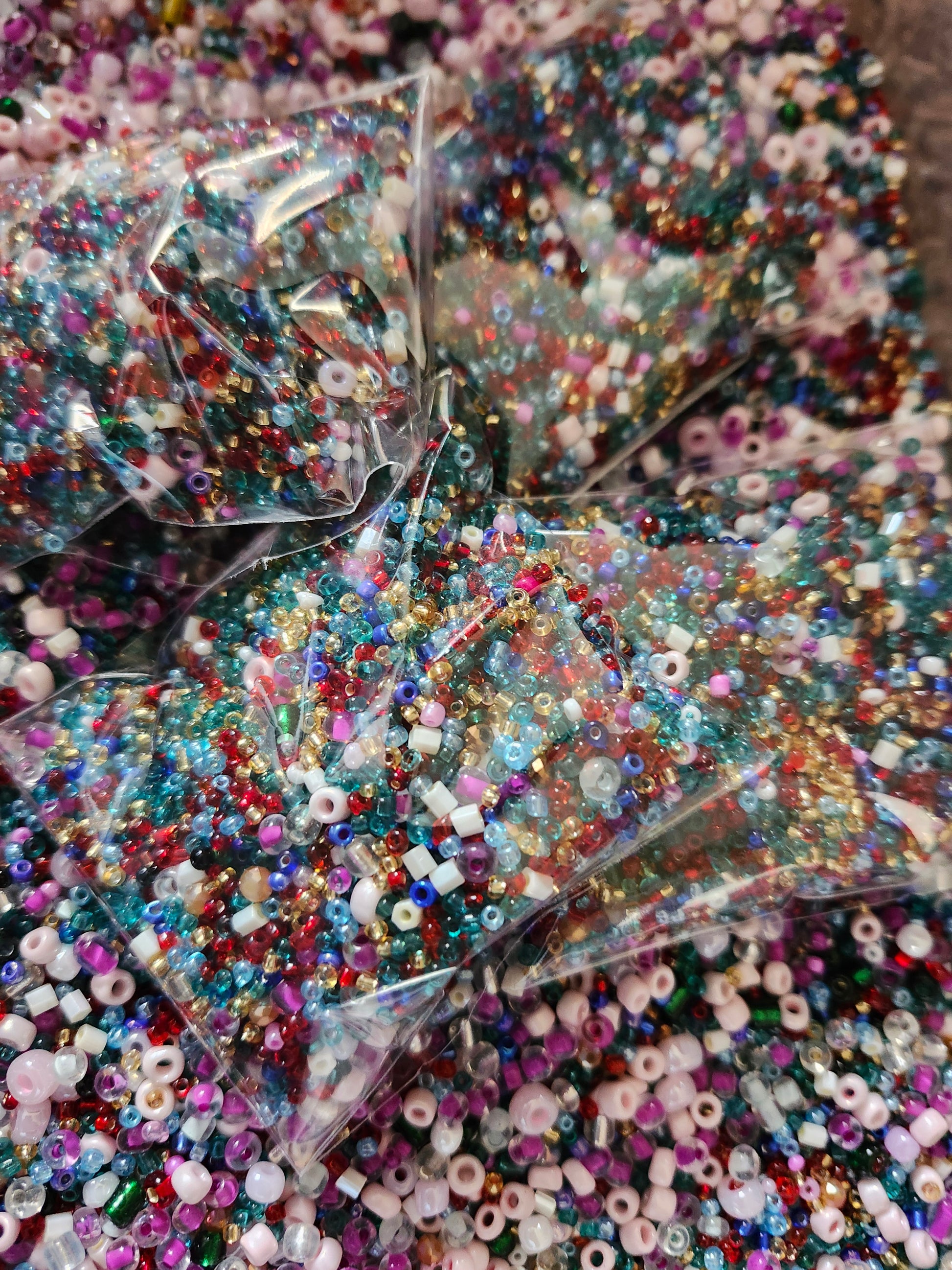 Assorted colorful glass seed beads in clear bags, perfect for crafting and jewelry making