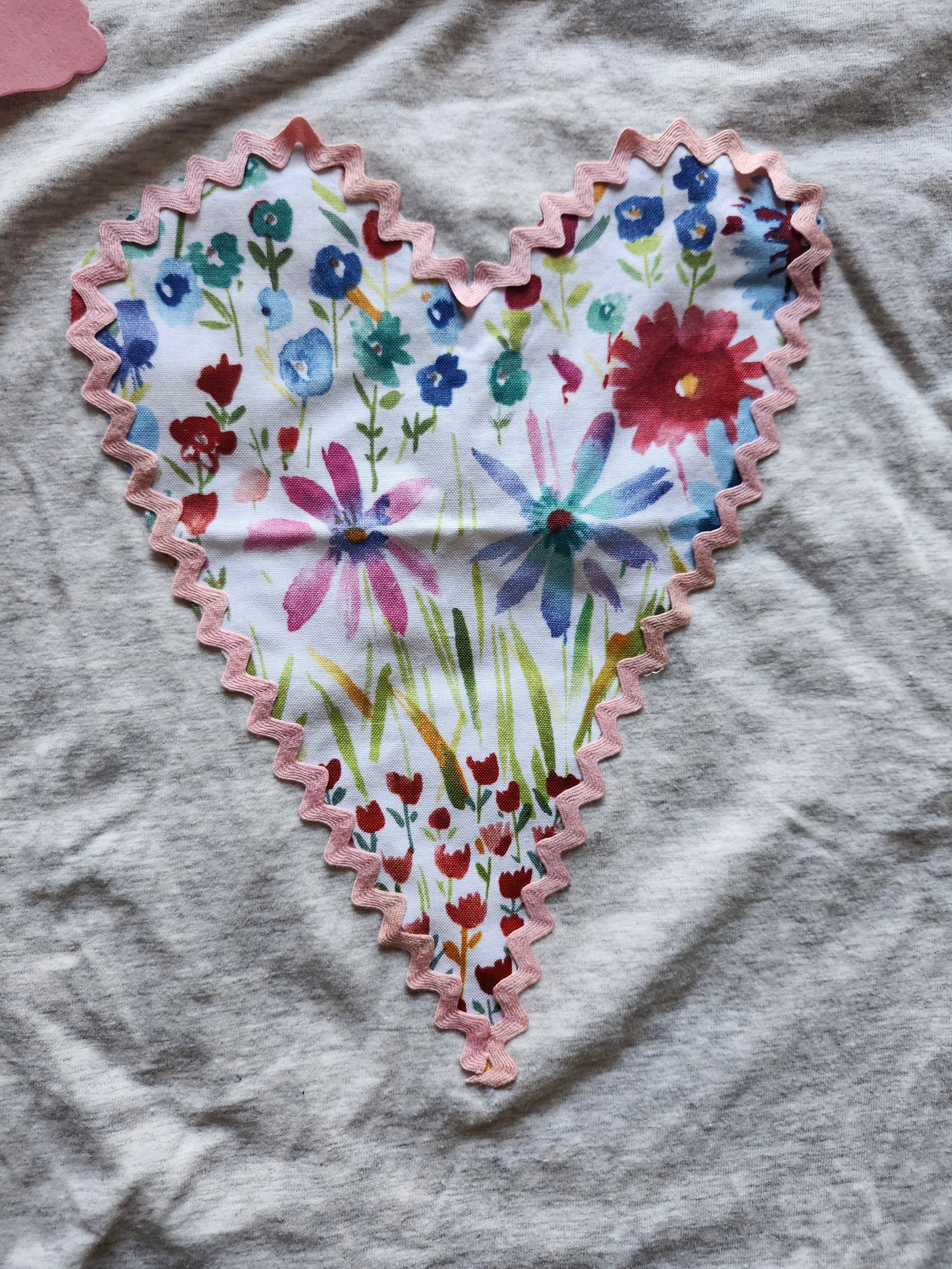 Handmade floral heart t-shirt with colorful floral design and pink scalloped edges