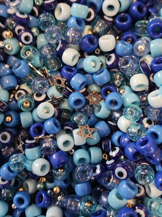 Colorful assortment of beads in blue for the Hanukkah jewelry making kit with star charms