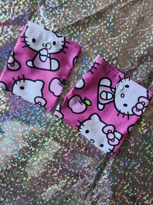 Two pink Hello Kitty kawaii pouches featuring cute graphics and white accents