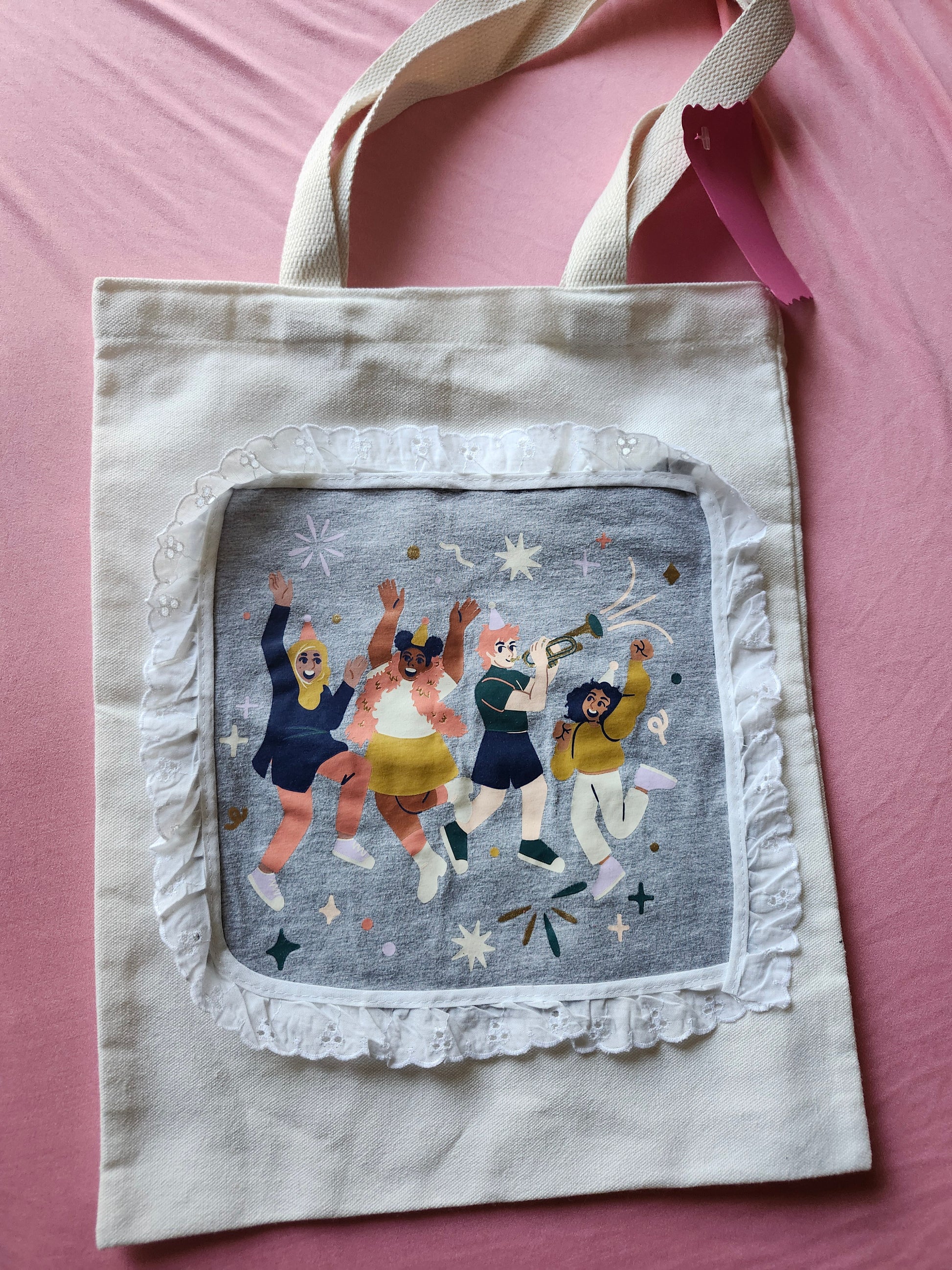 Inclusive design tote bag featuring colorful illustrations of diverse people celebrating joyfully