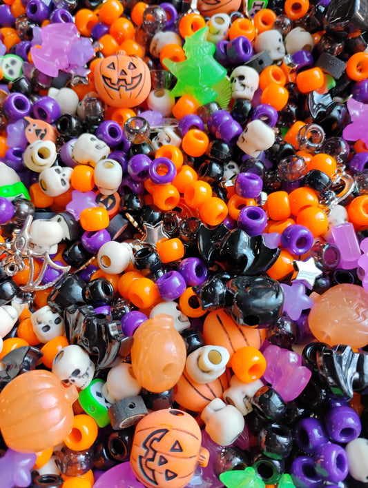 Colorful assortment of kandi beads Halloween in purple, orange, black, and green shapes for crafting