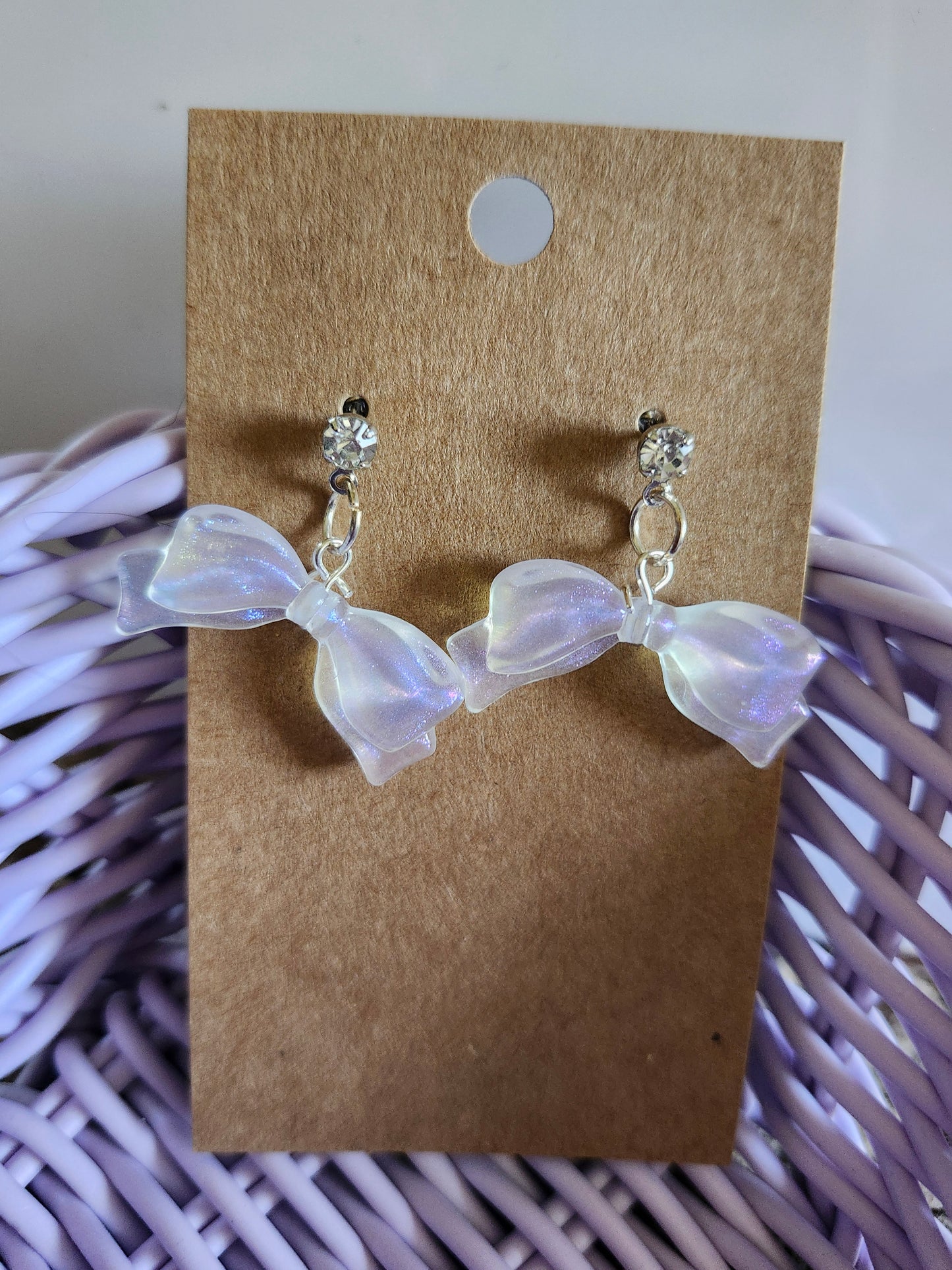 Kawaii bow earrings featuring iridescent bows and sparkling studs for a cute accessory look