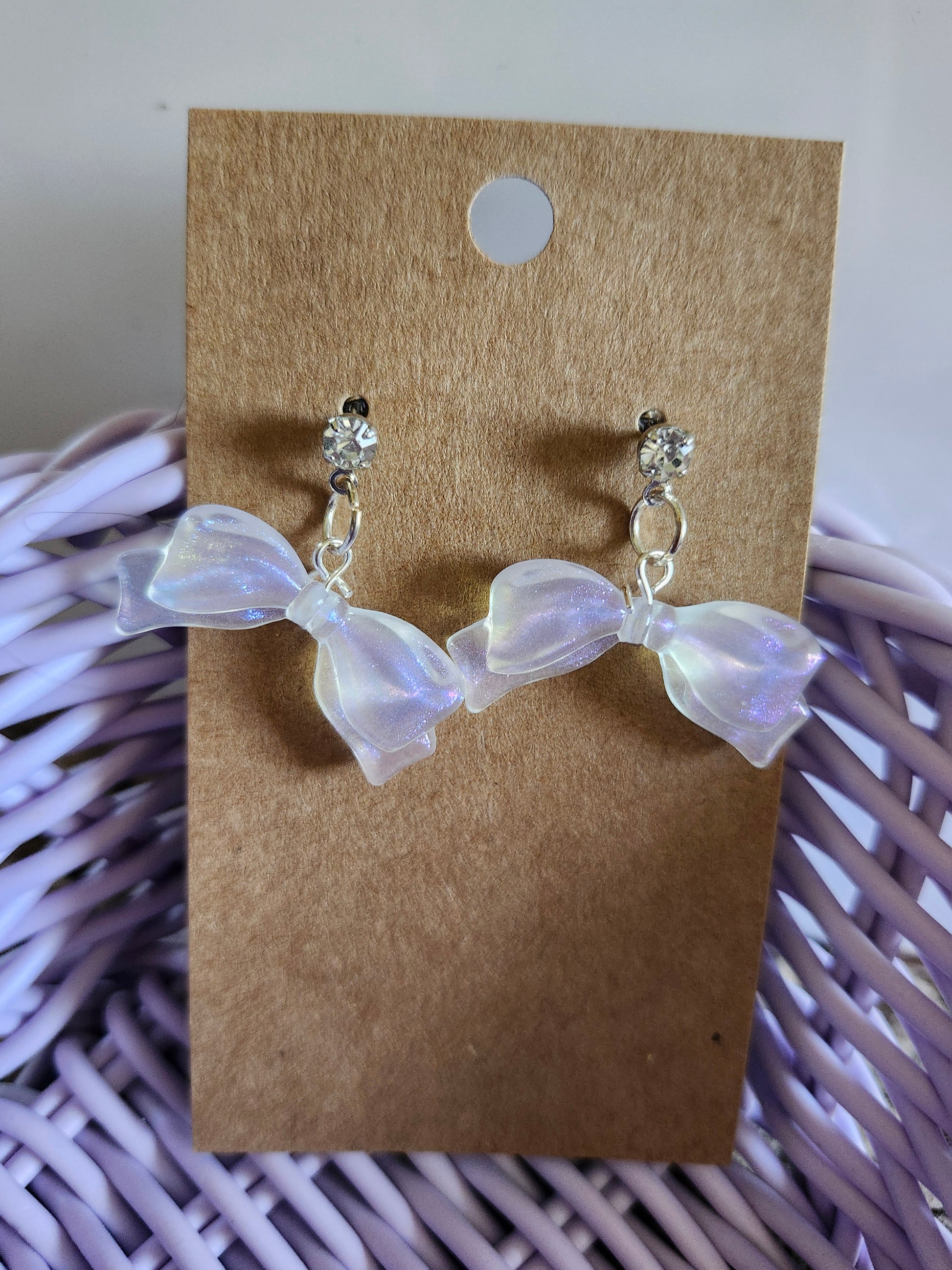 Kawaii bow earrings featuring iridescent bows and sparkling studs for a cute accessory look
