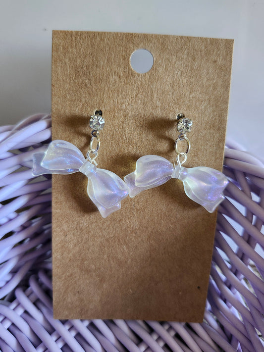 Kawaii bow earrings featuring iridescent bows and sparkling studs for a cute accessory look