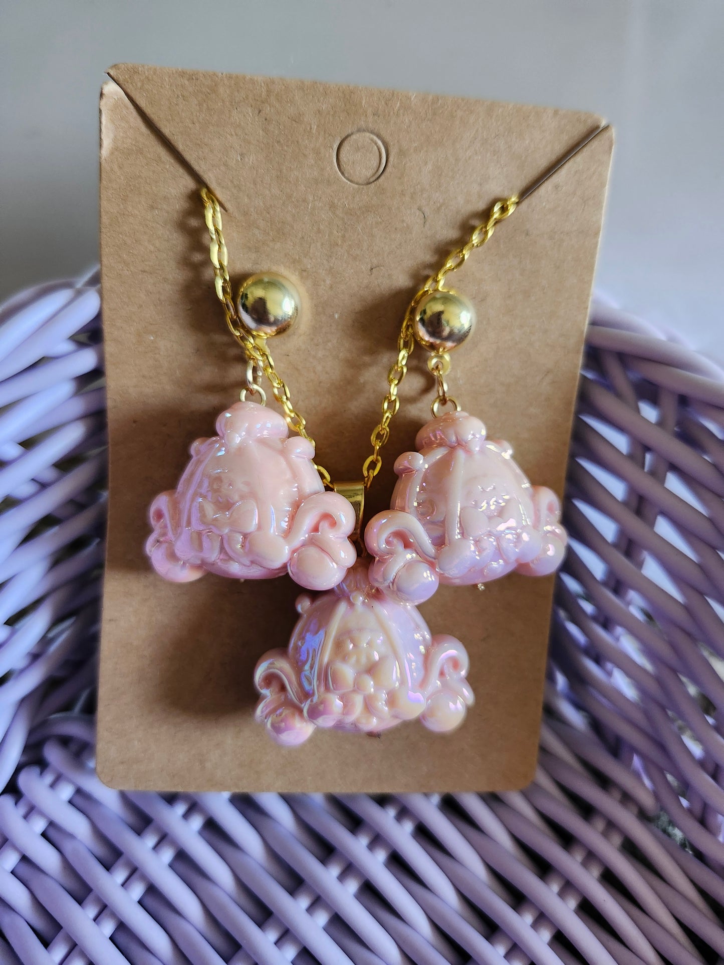 Kawaii Cinderella carriage jewelry set featuring three pink charm pendants on a gold chain