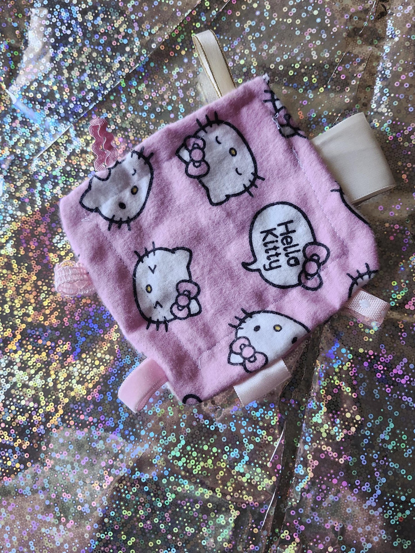 Kawaii Hello Kitty fidget toy in pink with Hello Kitty print and colorful tags for sensory play