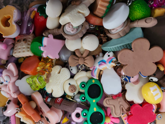 Colorful assortment of kawaii jewelry charms including food and cute characters for crafting