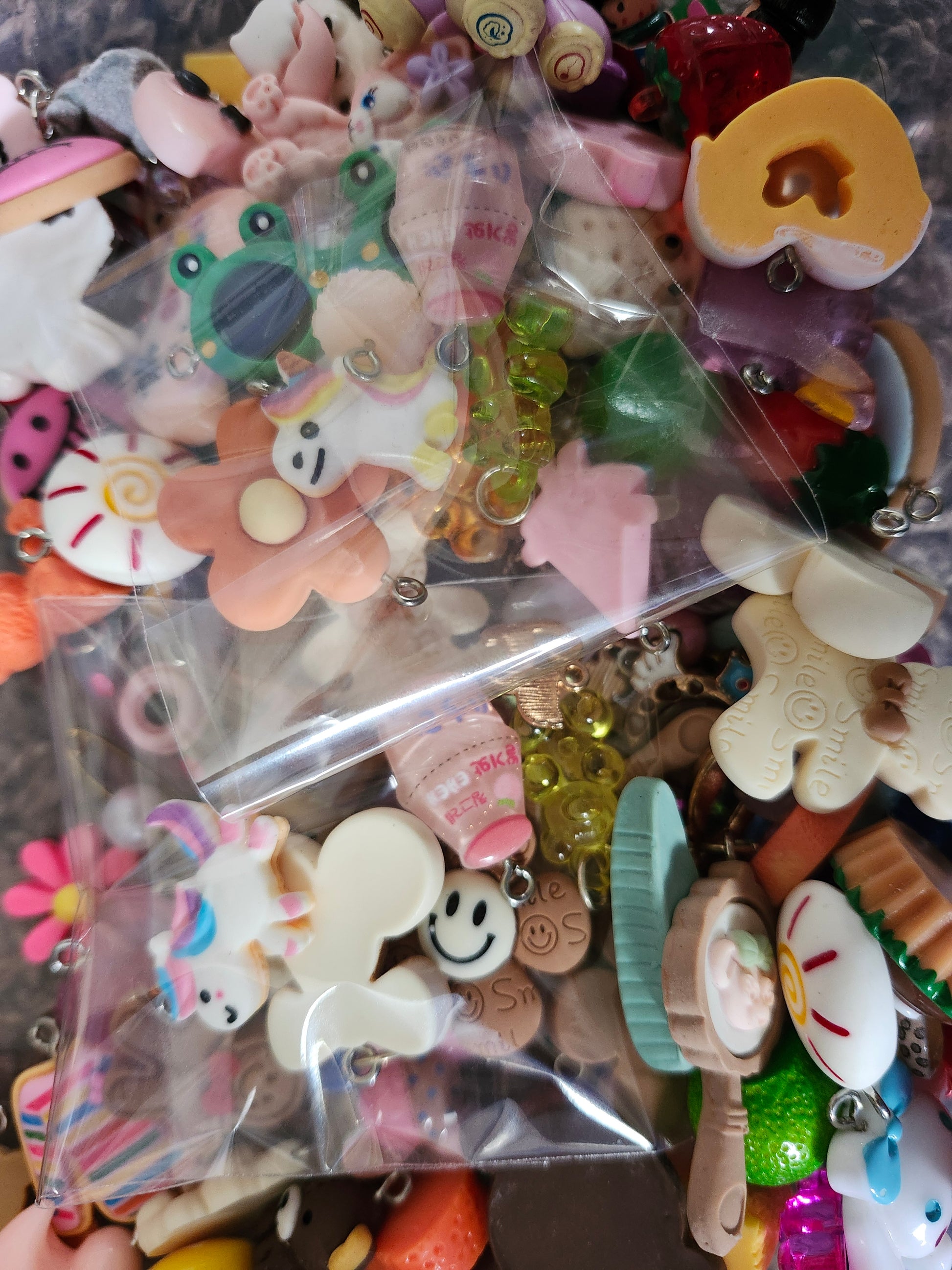 Colorful kawaii jewelry charms in various shapes and designs for crafting and accessories