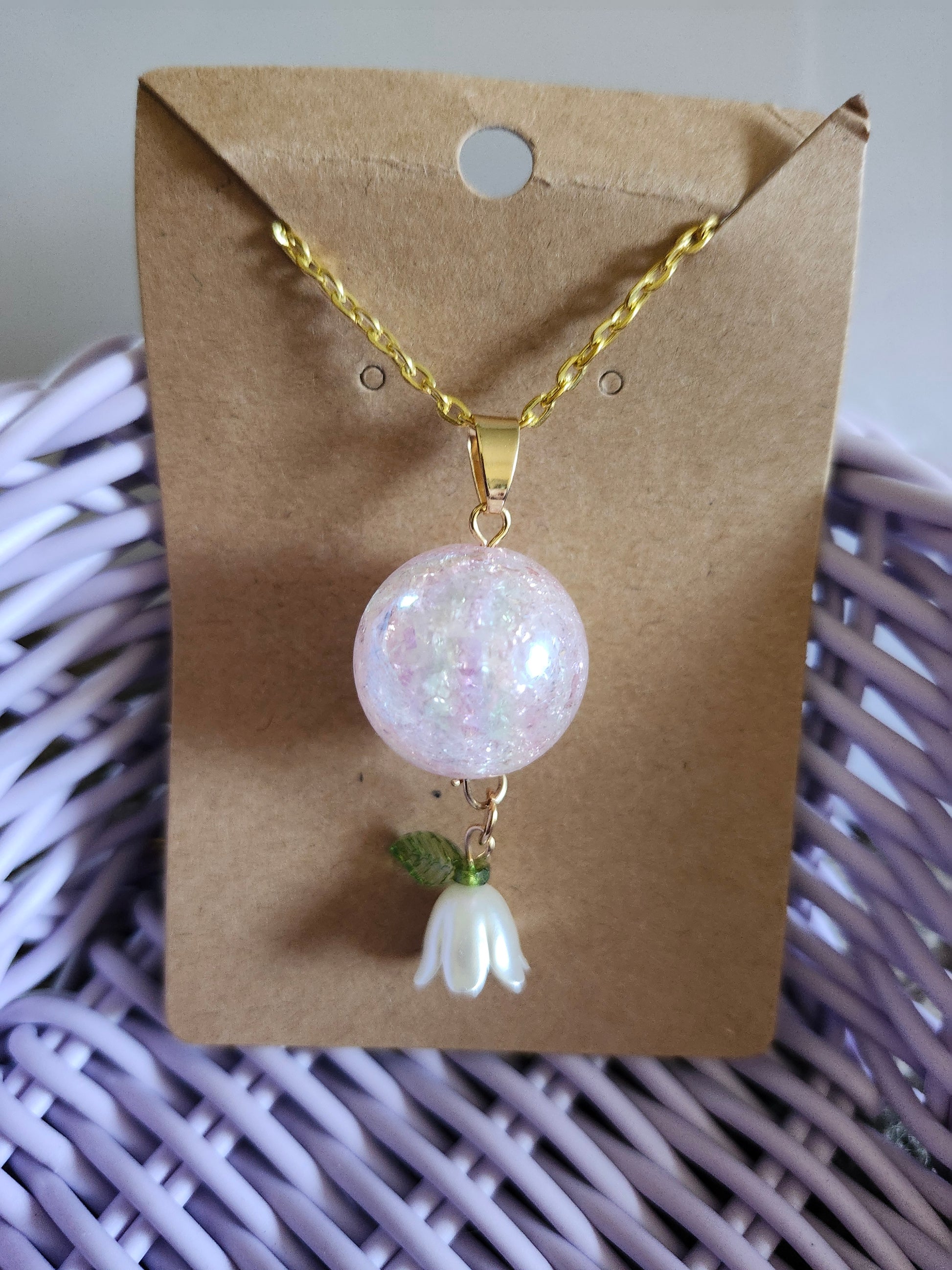 Kawaii pink lily necklace featuring a sparkling orb pendant and a delicate flower charm