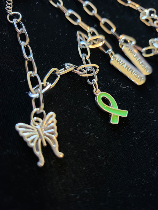 Mental health charm bracelet featuring a butterfly and green ribbon charms for inspiration and support