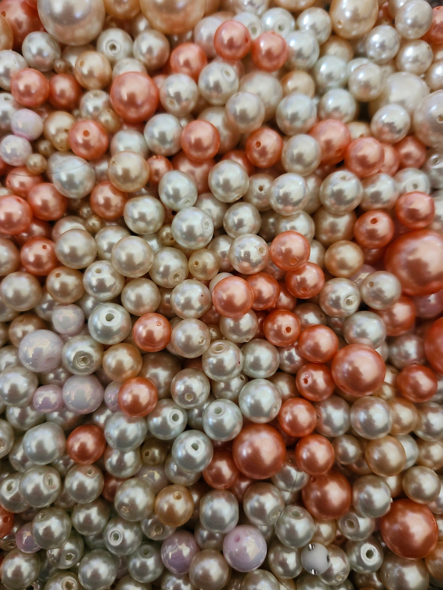 Assorted pink white pearls for jewelry making with various sizes and shades