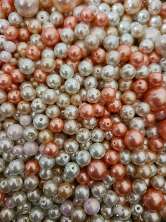 Assorted pink white pearls for jewelry making with various sizes and shades