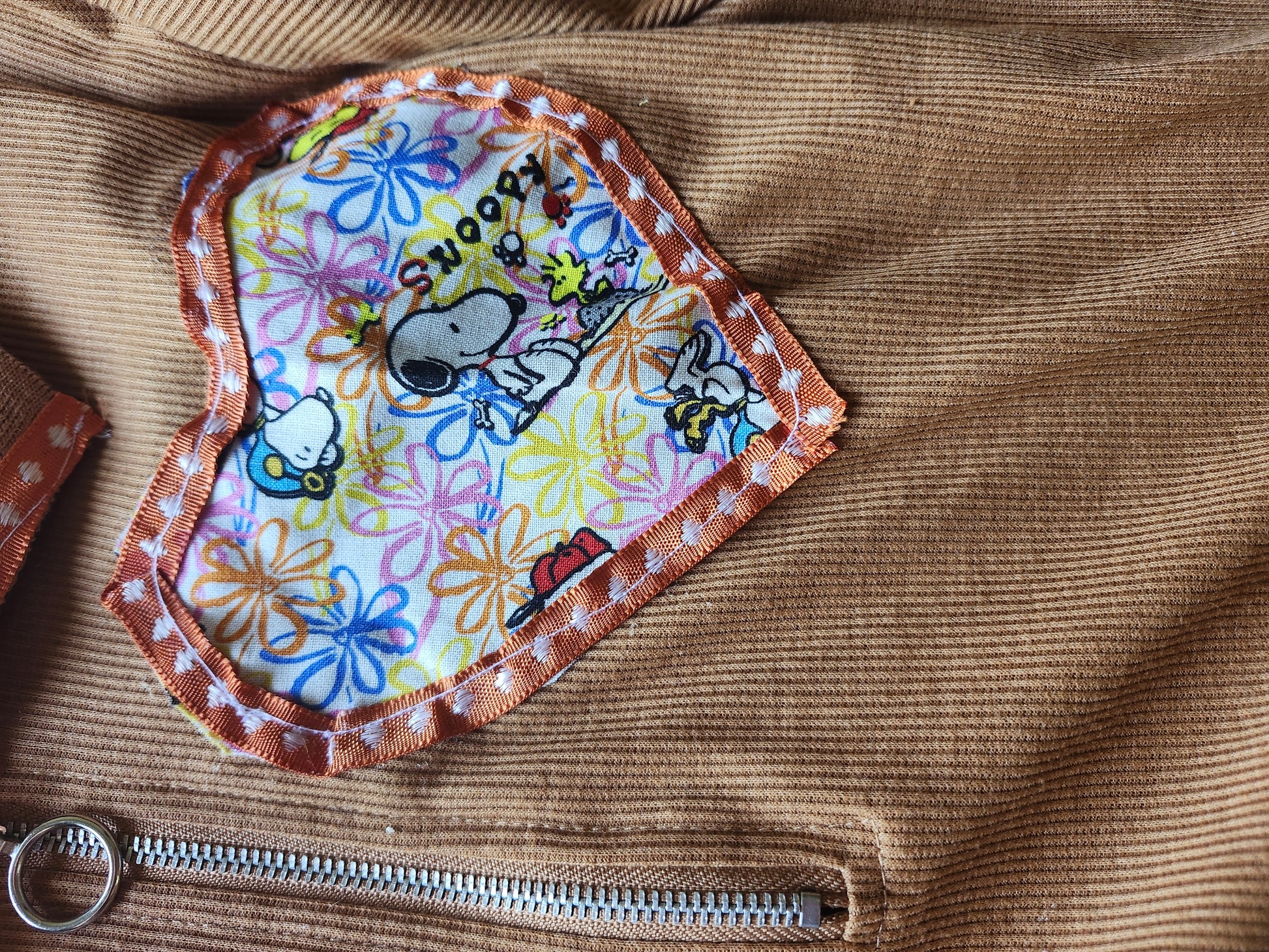 Snoopy heart crop top featuring a colorful flower patch design with Snoopy and friends