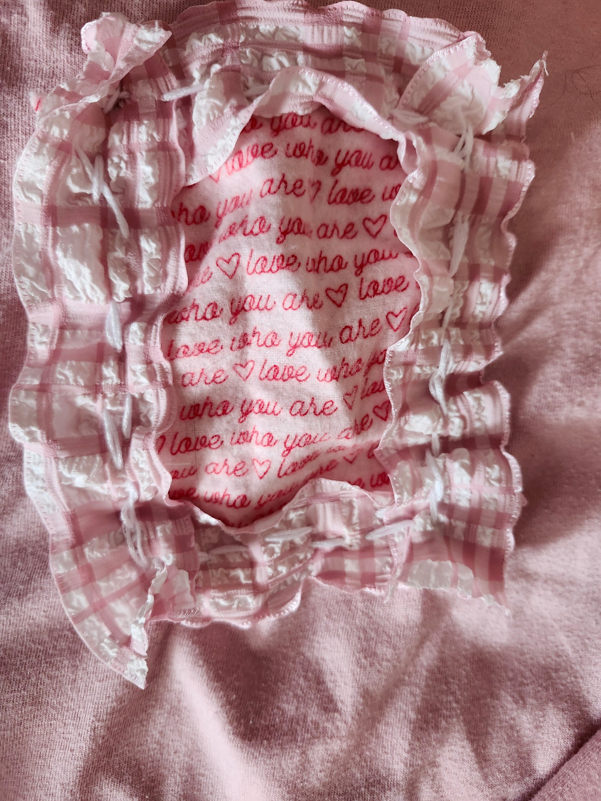 Pink spank-kei style clothing with ruffled edges and a love-themed inner print