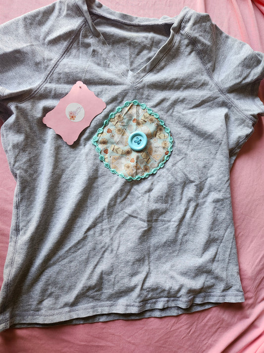 Gray Volkswagen upcycled tee with decorative floral patch and blue button detail