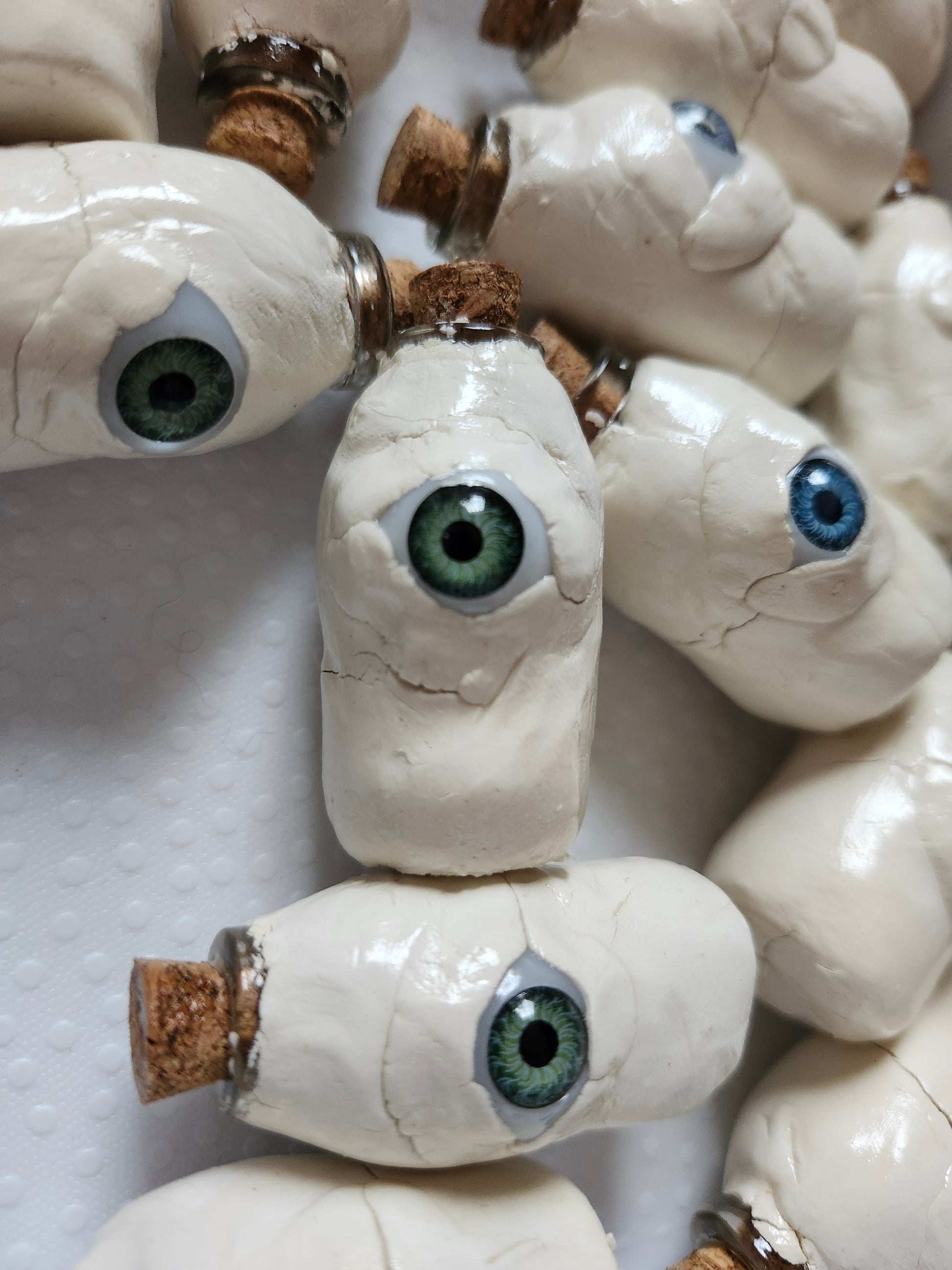 Handcrafted weirdcore decor featuring unique bottle eyes with vibrant green and blue accents