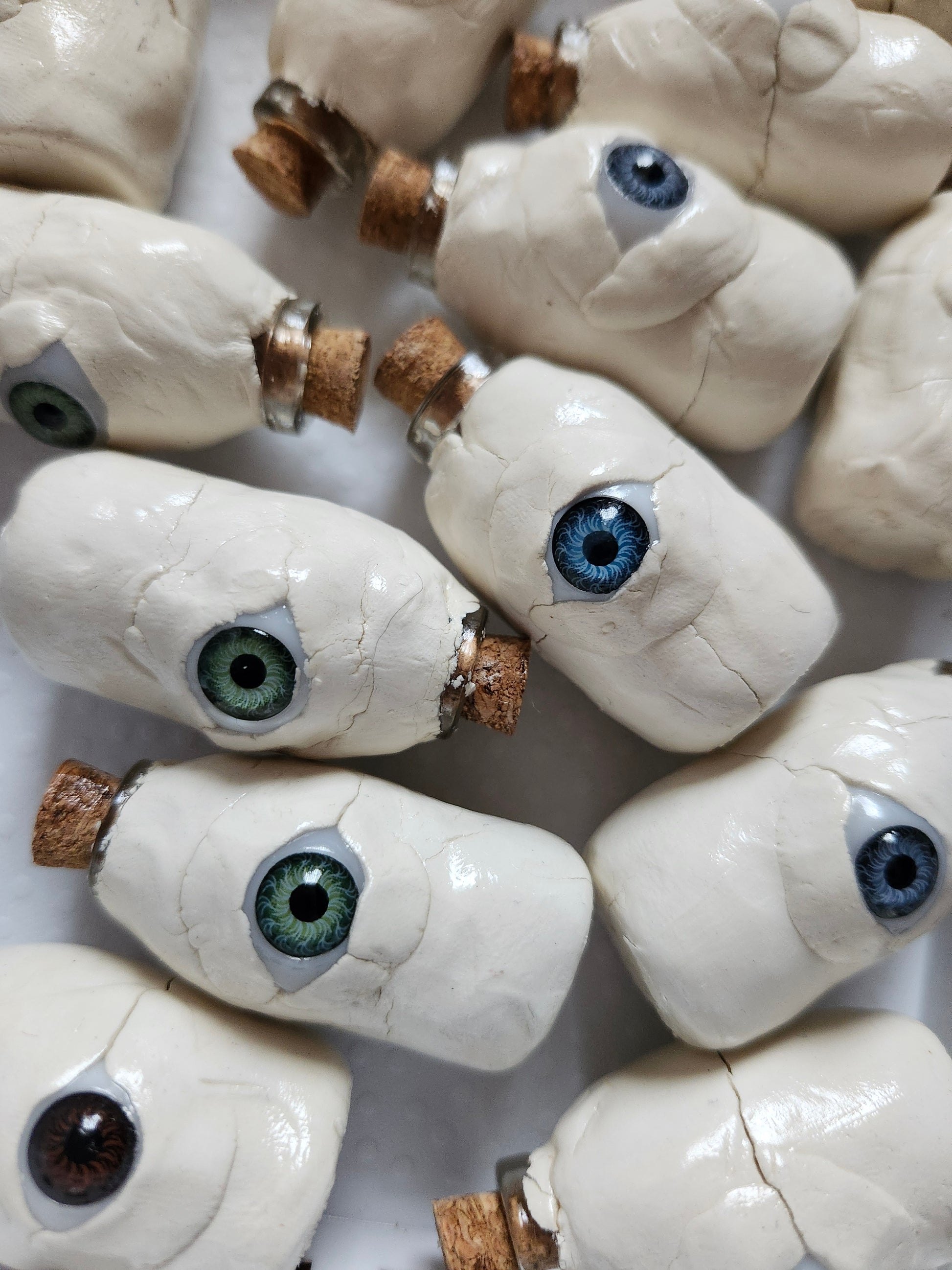 Unique weirdcore decor featuring handcrafted eye-inspired clay bottles with various colored eyes
