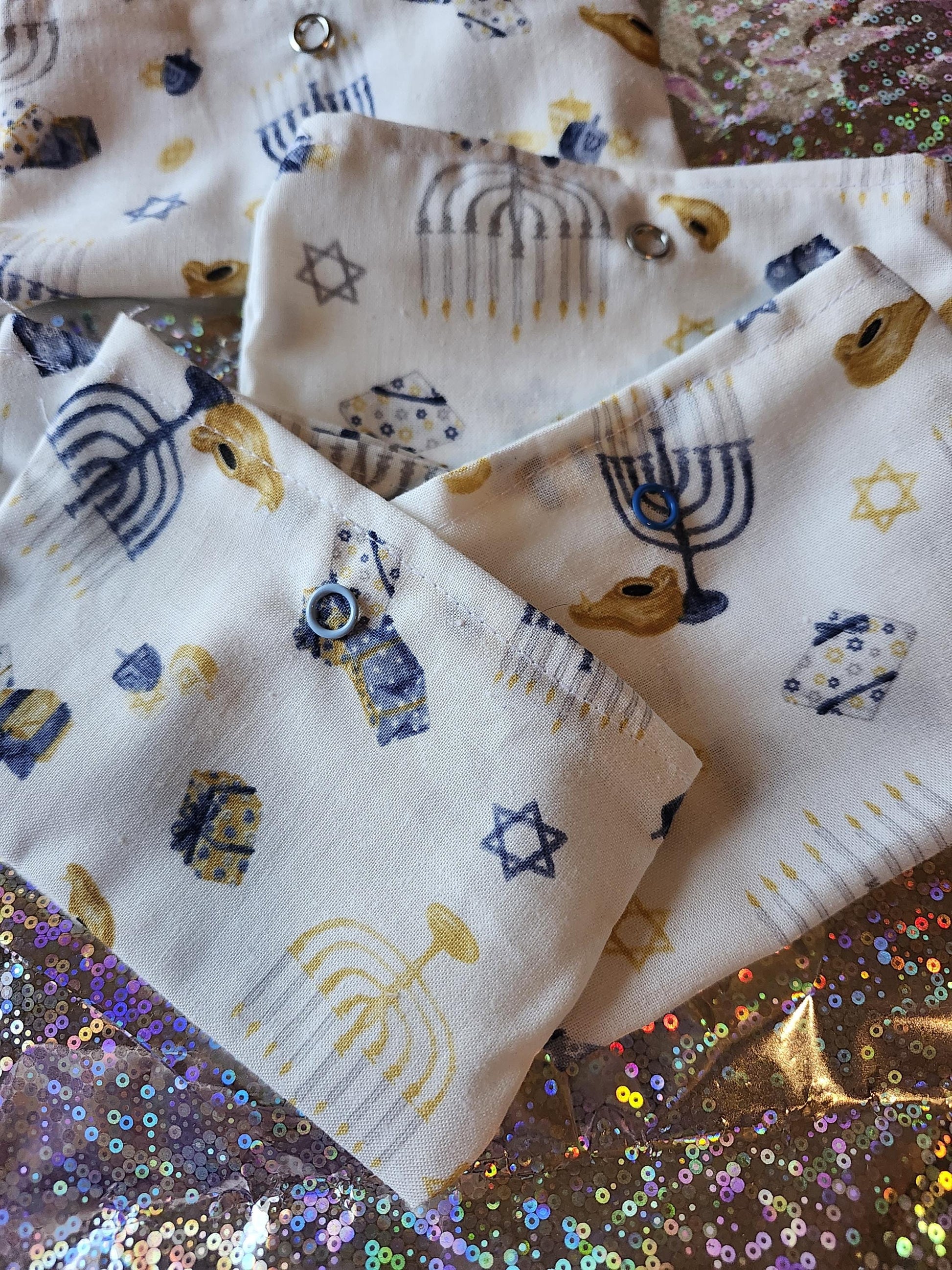 White Hanukkah gift pouch featuring colorful menorah and star of David designs for festive celebrations