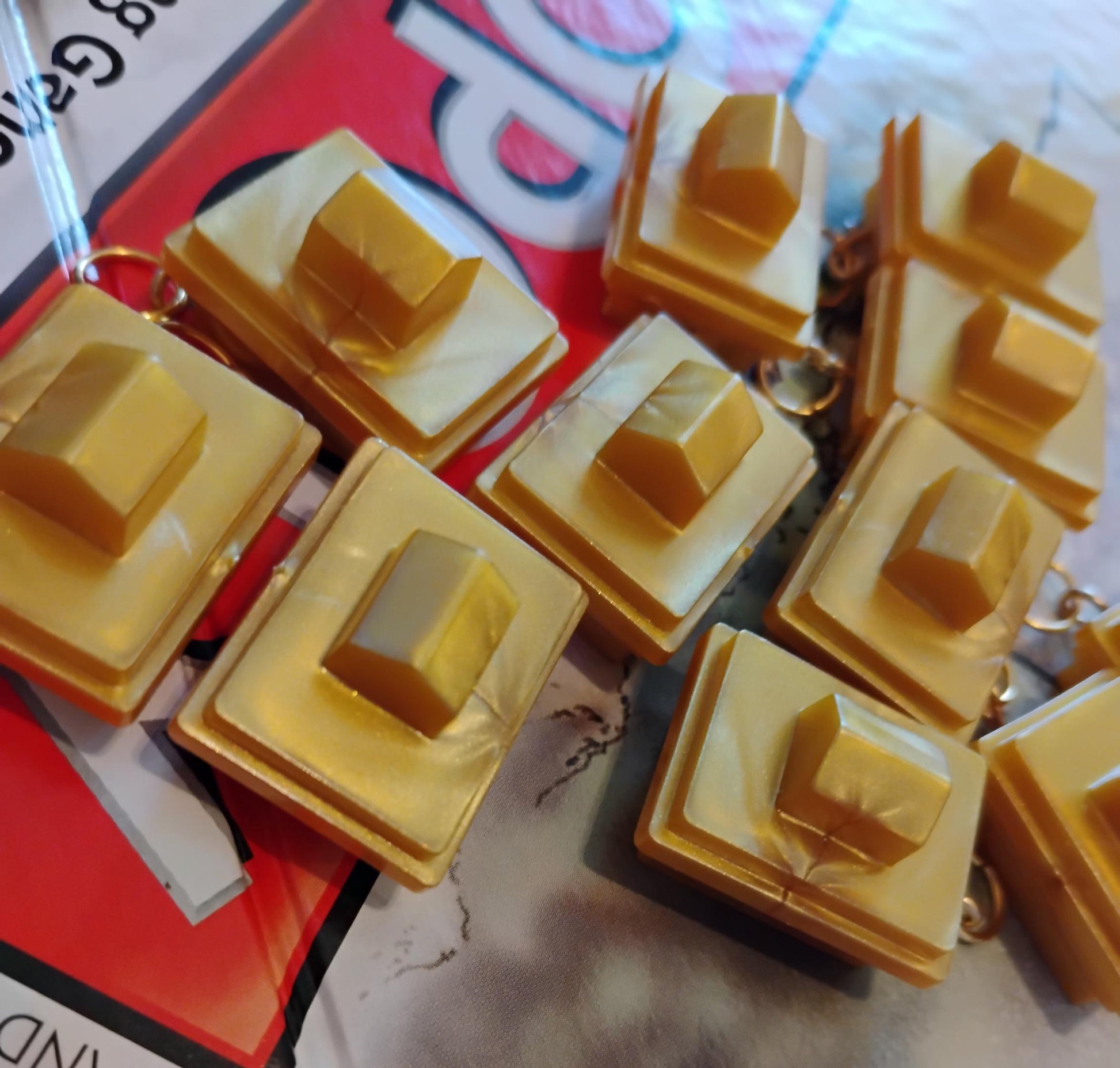 Set of unique yellow square cake slice keychains with raised top for playful decor
